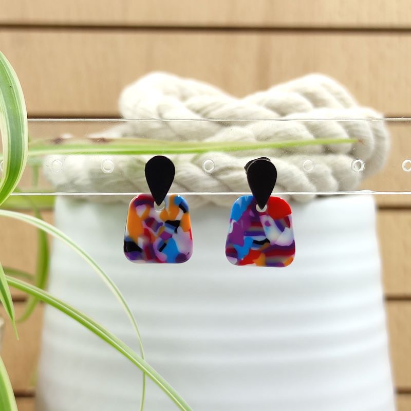 Bunter Ohrring „Mira“ in modernem Design – Kombination aus eckiger Form und tropfenförmigem Stecker. Jeder Ohrring ist ein handgefertigtes Unikat mit individuellem Farb- und Musterverlauf. Wasserfest, besonders leicht und allergikerfreundlich – ideal für empfindliche Haut und den täglichen Gebrauch. Minimalistisch, farbenfroh und stilvoll zugleich.